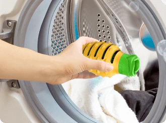 lady placing Laundry Masher in washing machine